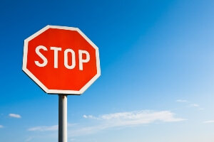 image of a stop sign against a bright blue sky