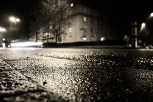 low ground-level image of black ice on local road at night